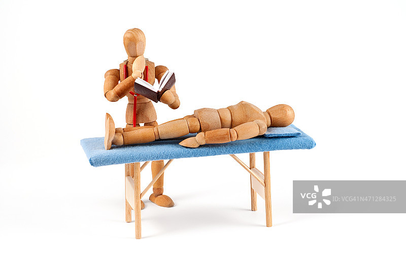 医生在寻找诊断-深思熟虑的木制人体模型图片素材