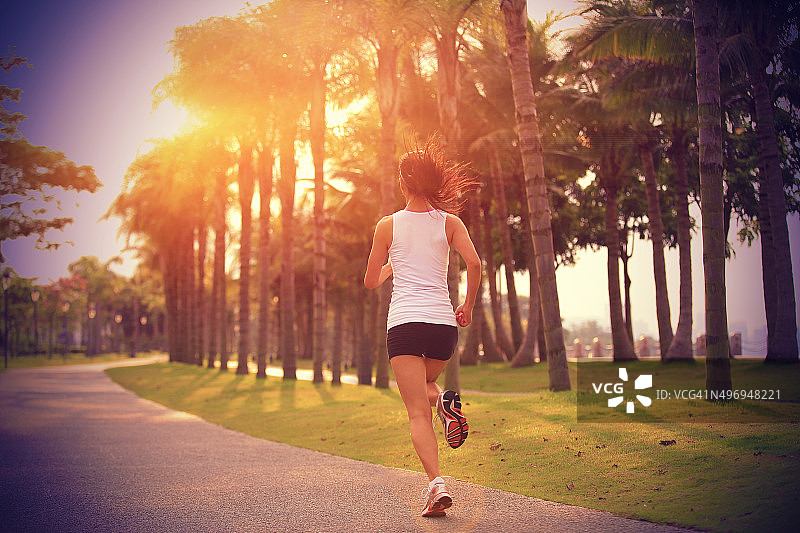 健康生活方式亚洲女人在热带公园慢跑图片素材