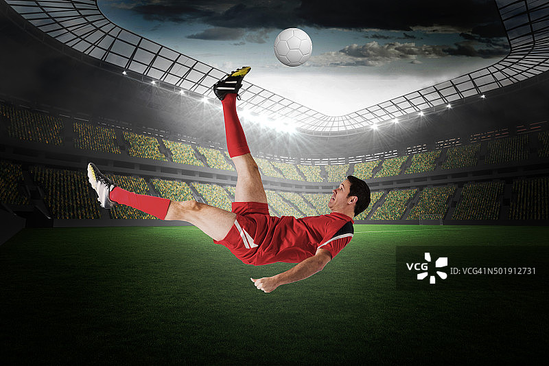 穿红色衣服踢球的足球运动员图片素材
