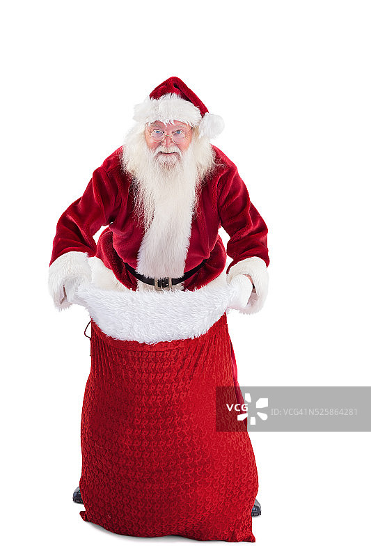 圣诞老人打开他的红色袋子图片素材