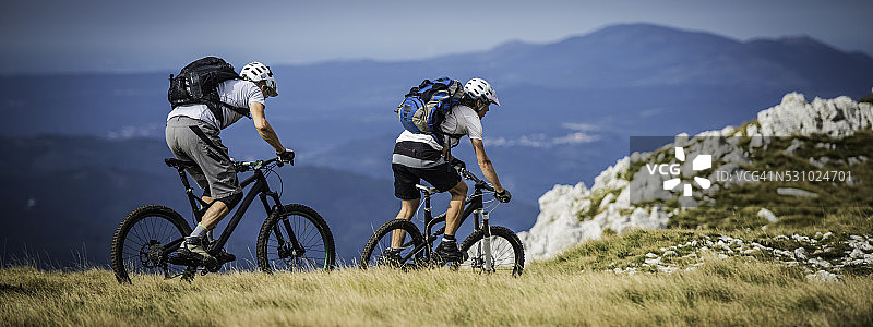 骑在山间小道上的自行车手图片素材
