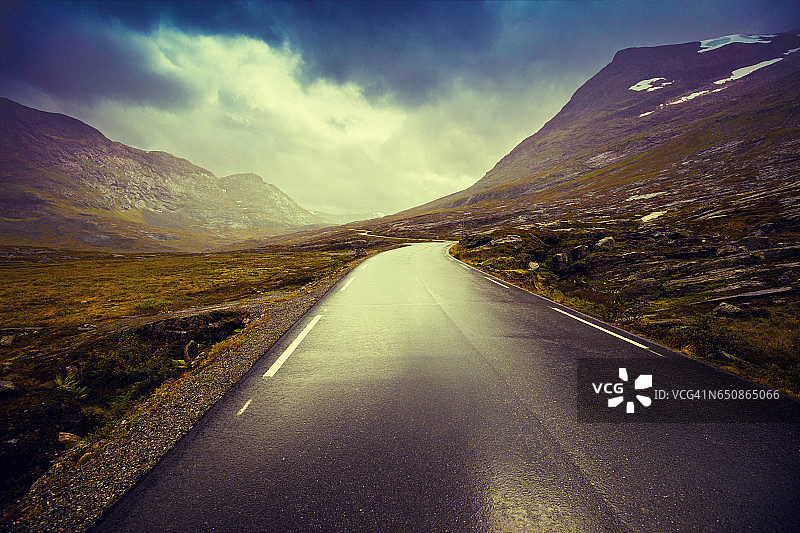 在山路上开车。挪威美丽的大自然。日落图片素材