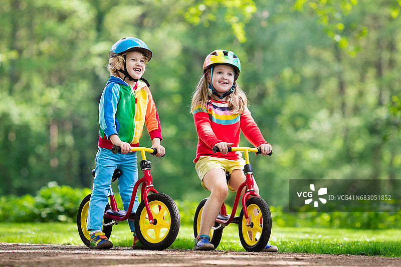 孩子们在公园里骑平衡自行车图片素材