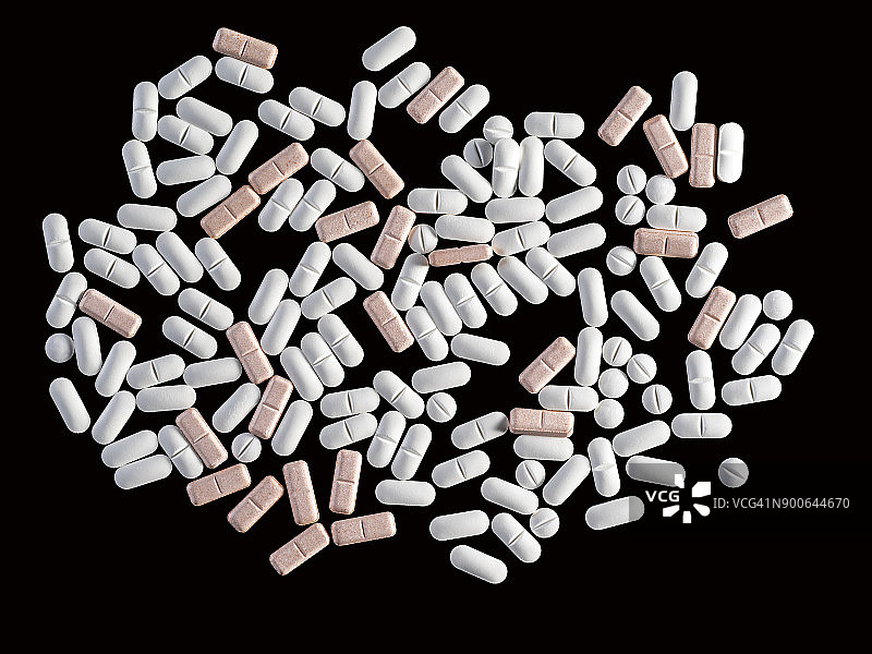 全帧堆各种颜色的药丸和胶囊，药物，近景上的黑色背景。图片素材