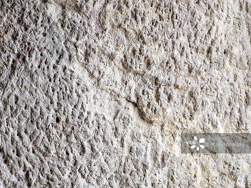 在岩石中挖掘的古城墙的完整框架纹理。高分辨率的照片。图片素材