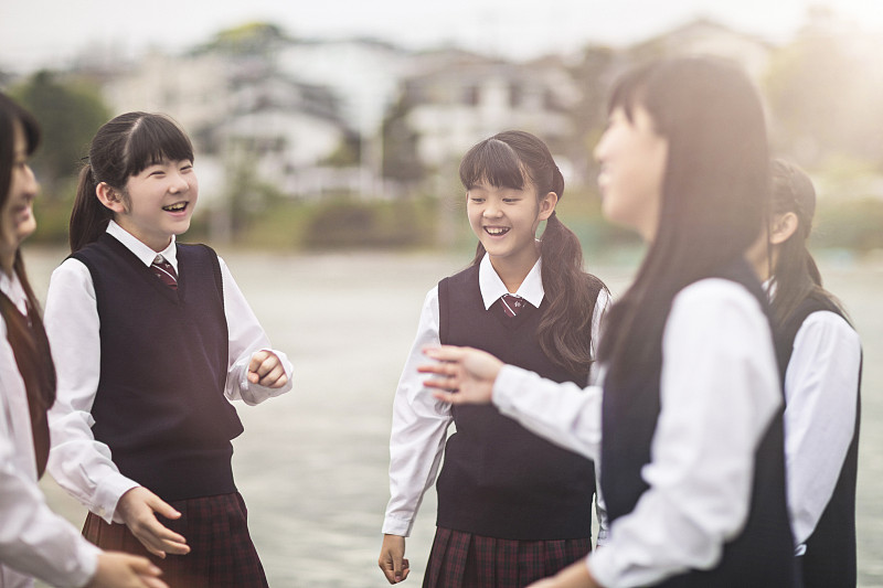 日本学生女孩在校园里说话图片素材