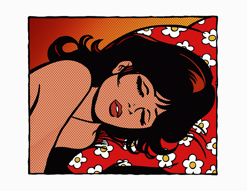 美丽的女人躺在花图案的枕头上睡着了图片素材