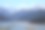 白雪皑皑的群山映衬下的湖景摄影图片