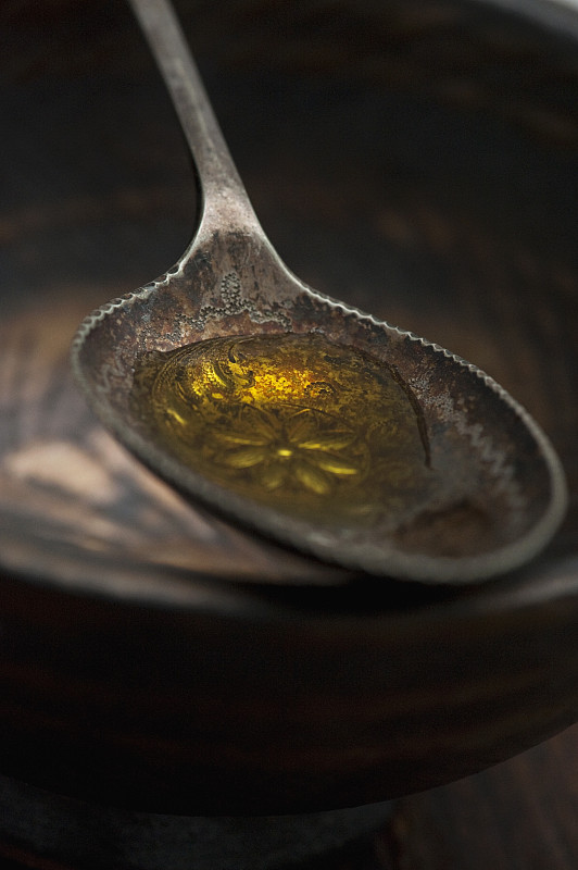 Close up of spoonful of olive oil图片下载