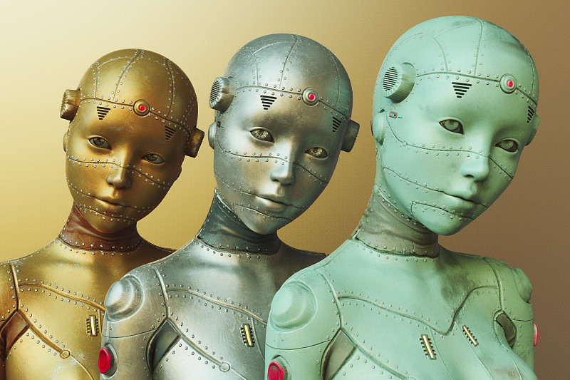 三个女机器人由金色，银色和蓝色的金属制成图片素材