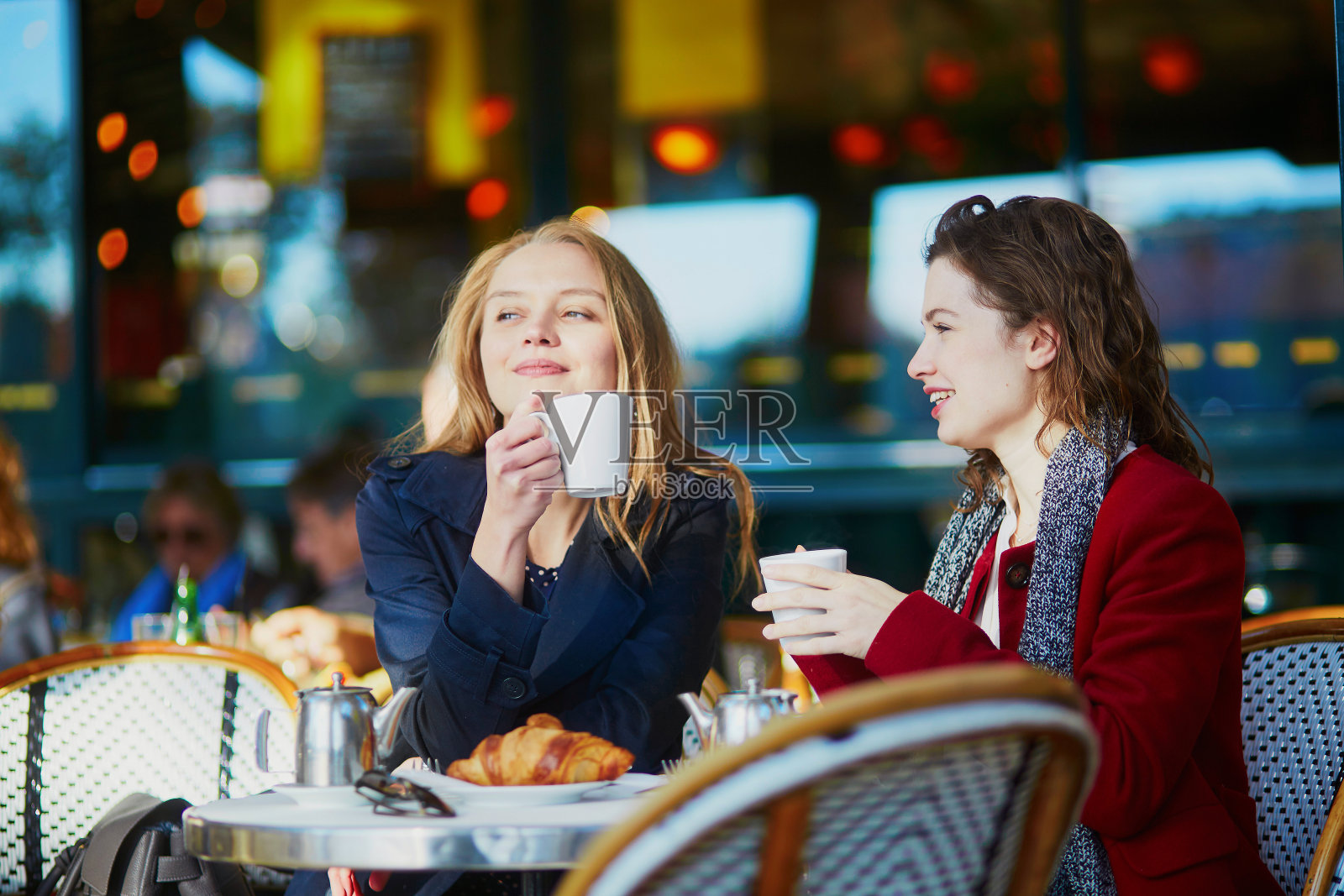 两个年轻女孩在巴黎的露天咖啡馆照片摄影图片