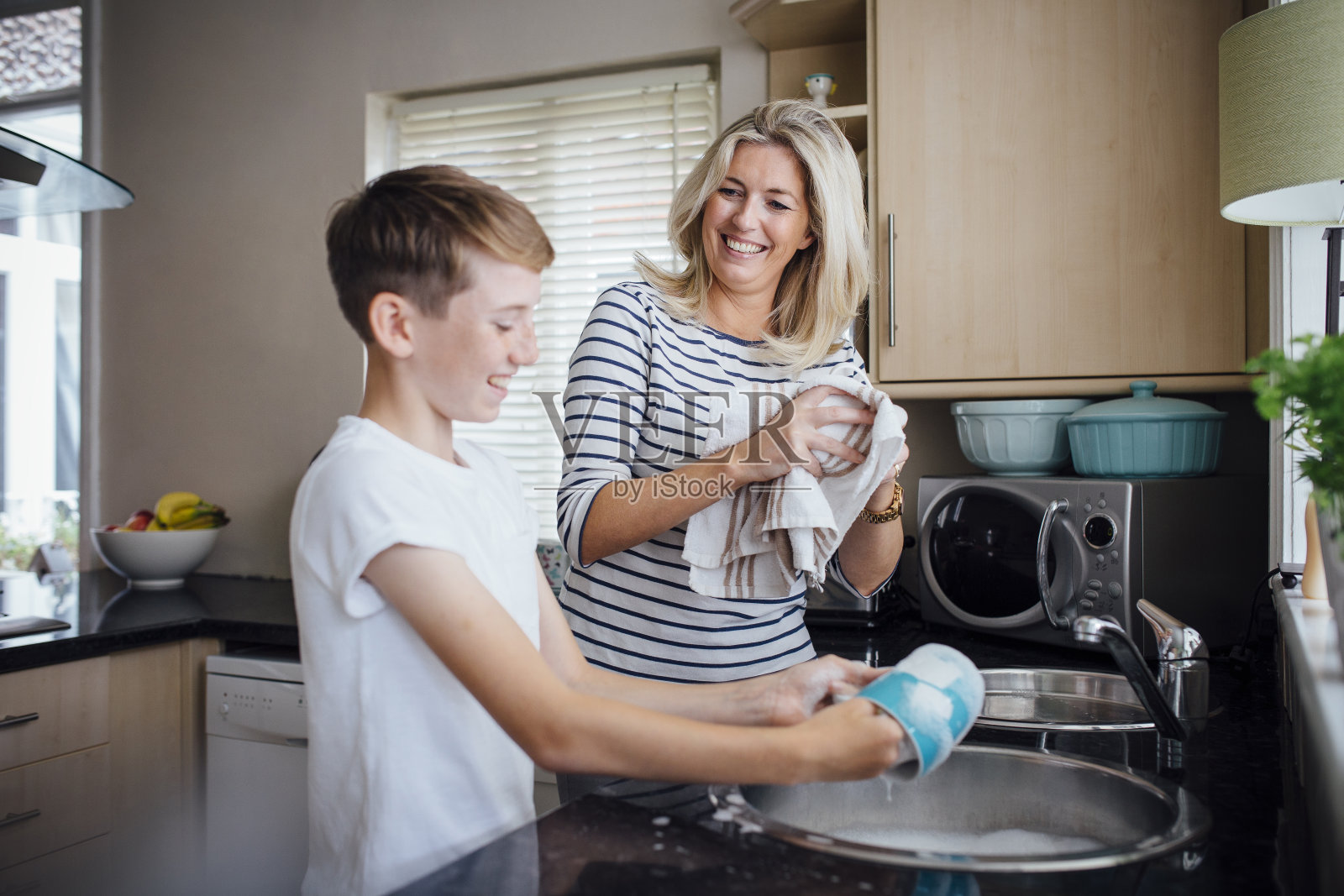 母亲和儿子在洗碗照片摄影图片