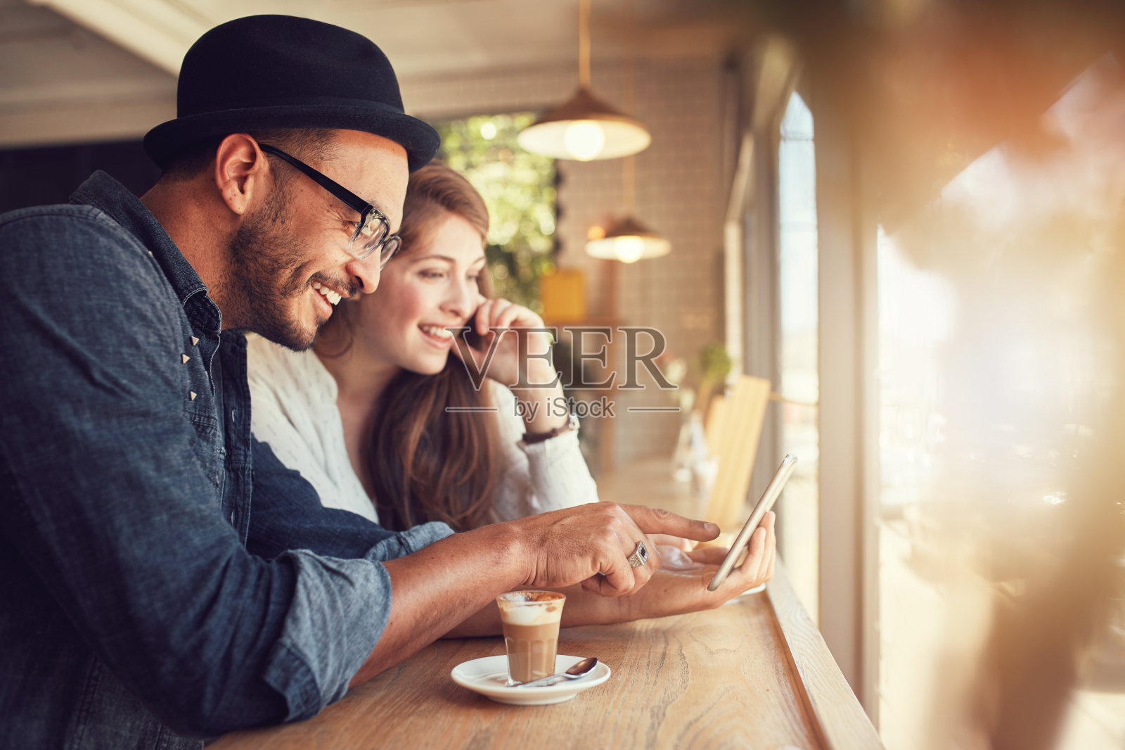 一对情侣在咖啡店里使用平板电脑照片摄影图片