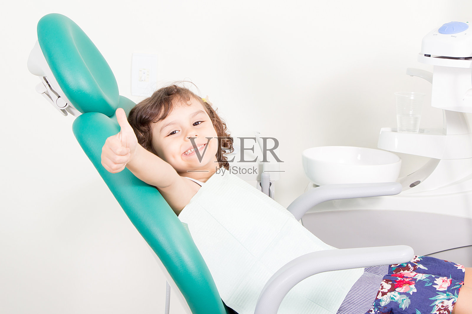 快乐可爱的小女孩在牙科诊所照片摄影图片