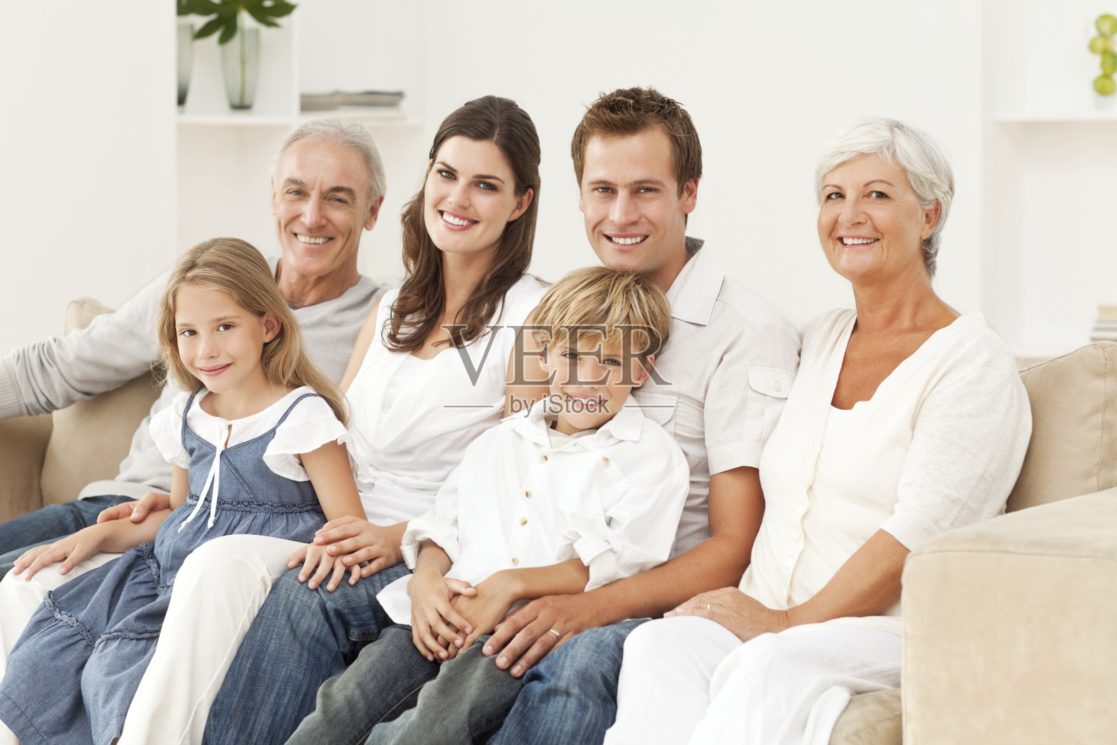 微笑的家人坐在沙发上照片摄影图片