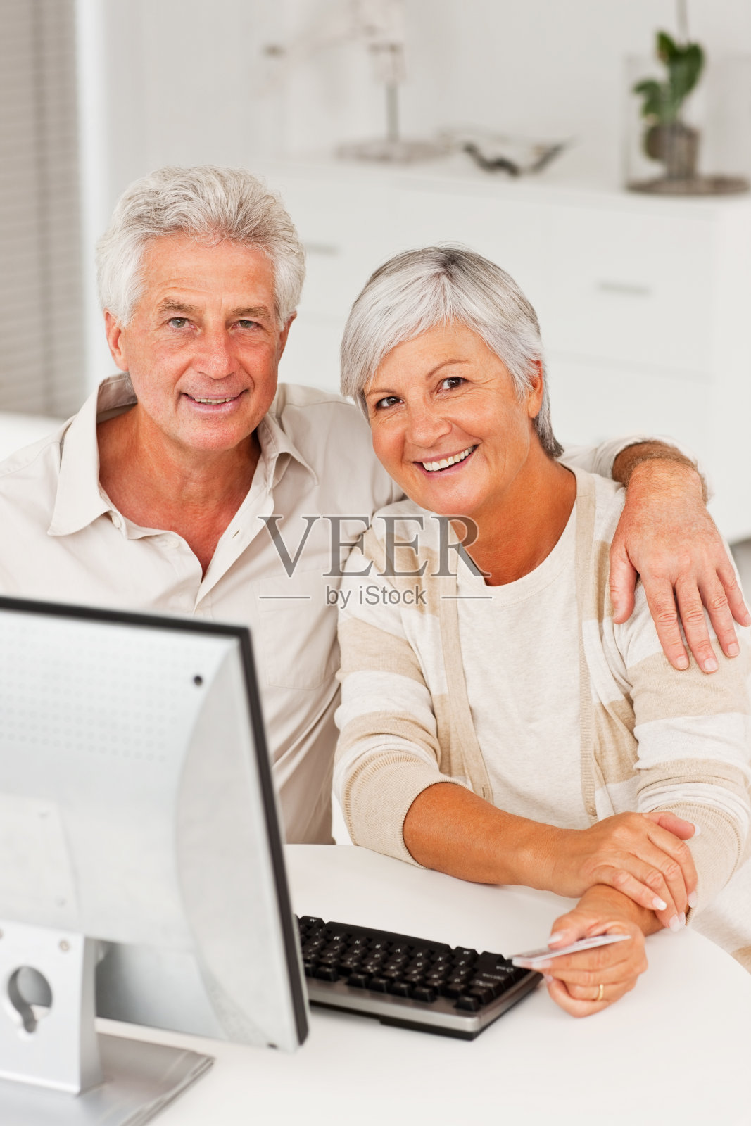 微笑的老年夫妇使用信用卡和网上购物照片摄影图片