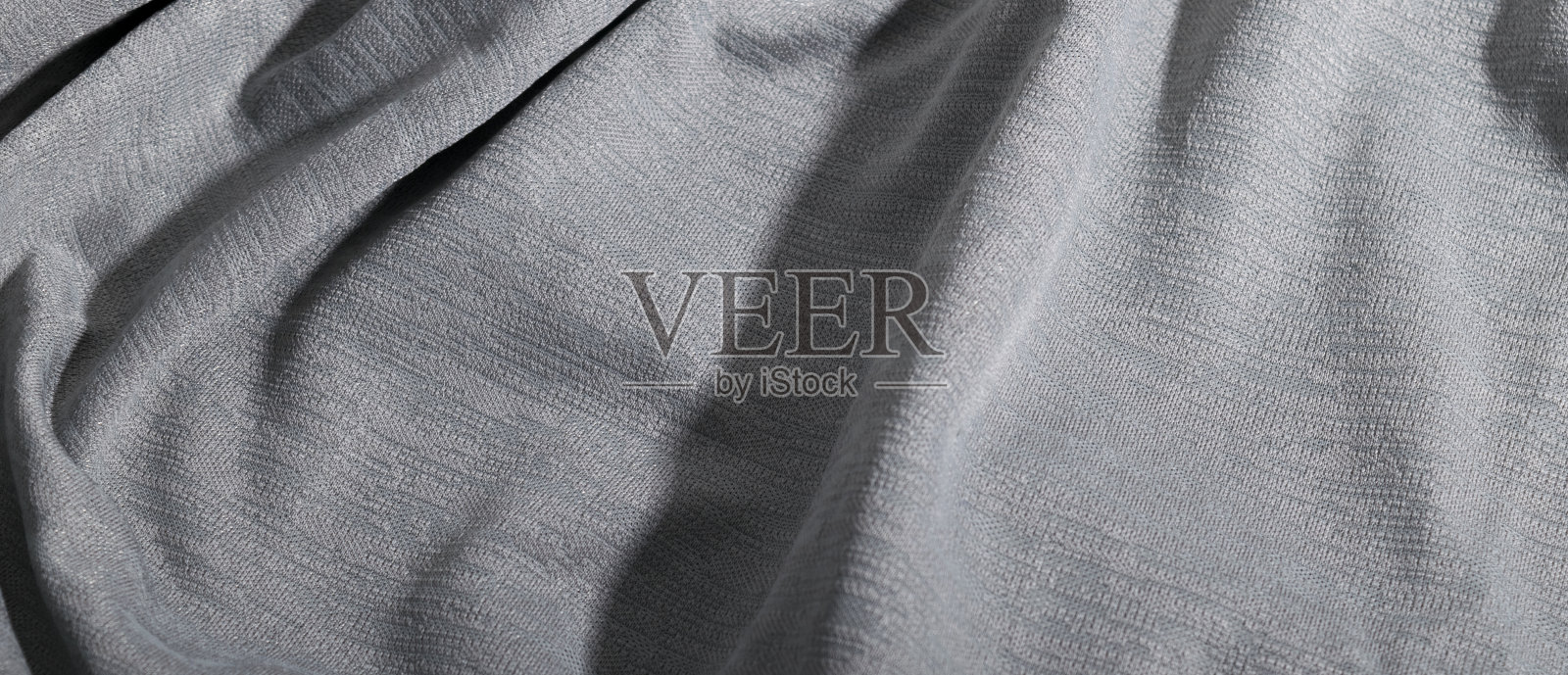 抽象典雅的浅灰色面料，灰色纺织背景。照片摄影图片