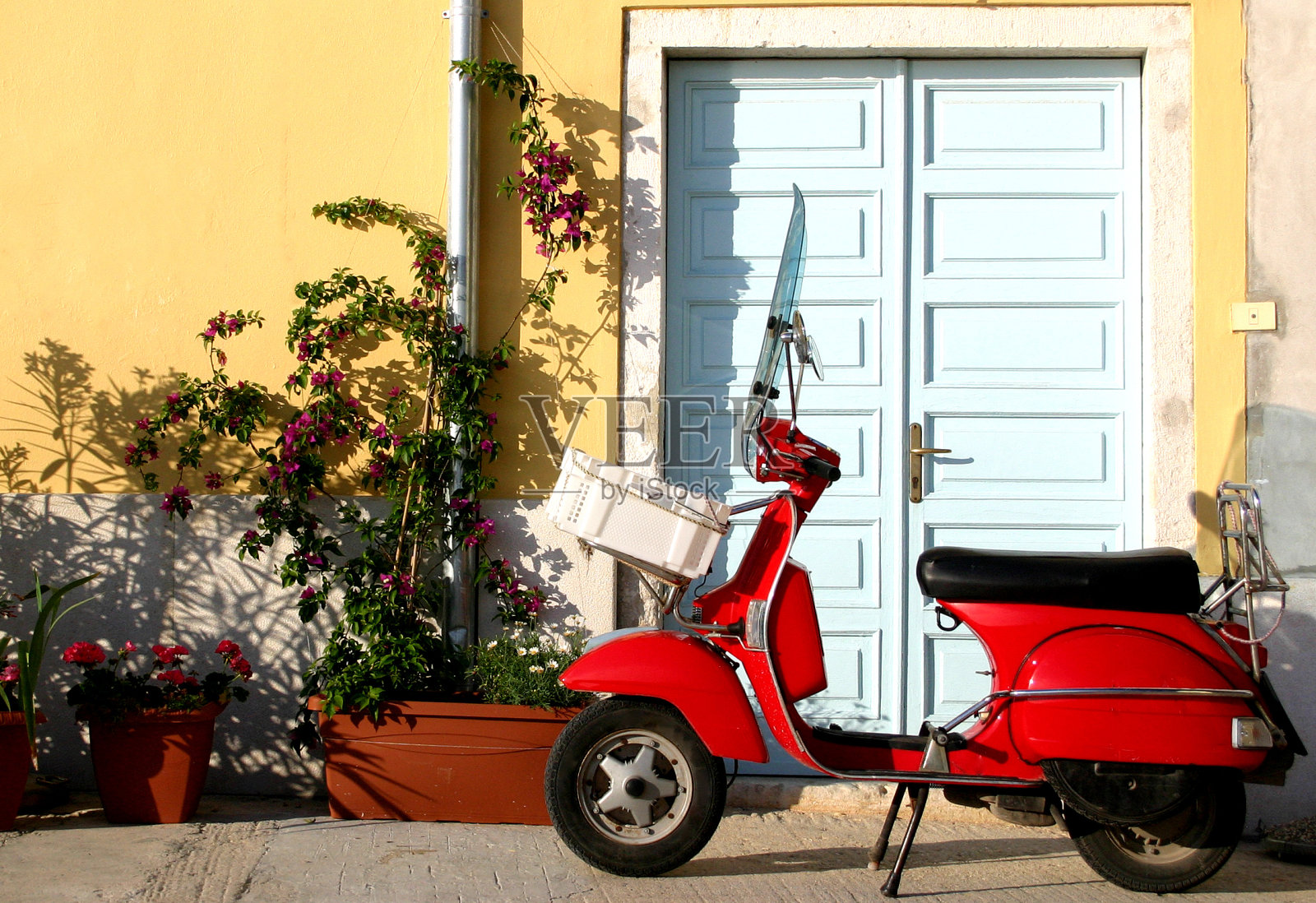 靠近门的意大利老式红色滑板车照片摄影图片