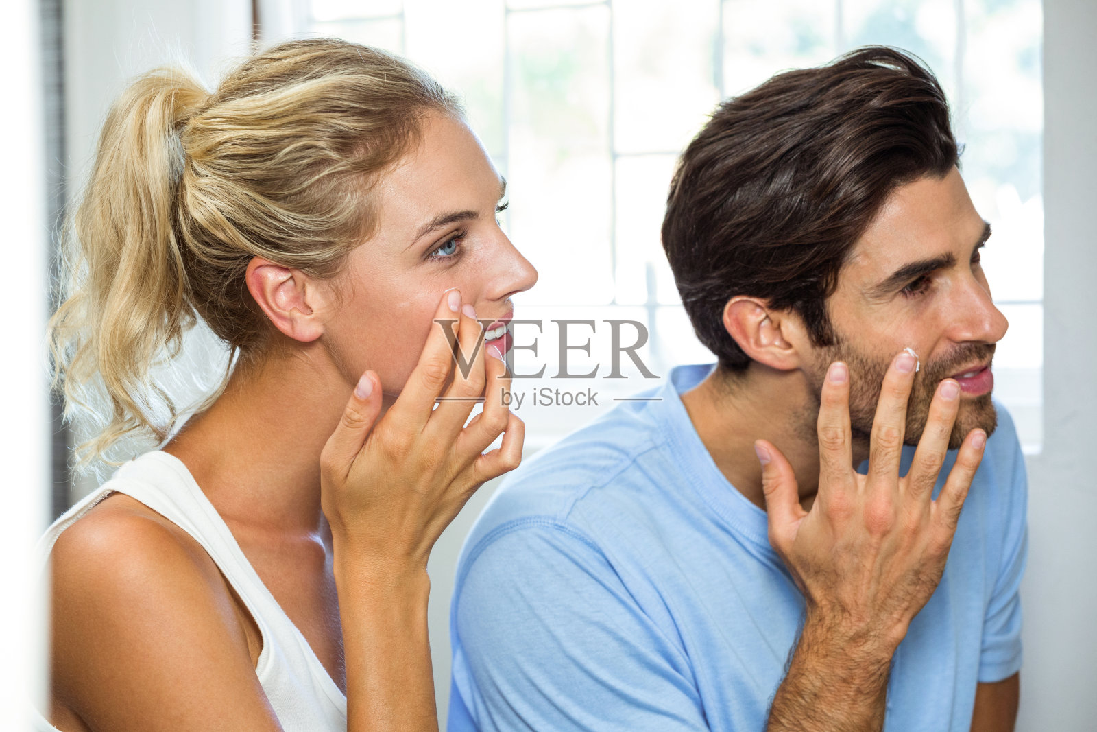 男人和女人在脸上涂抹保湿霜照片摄影图片