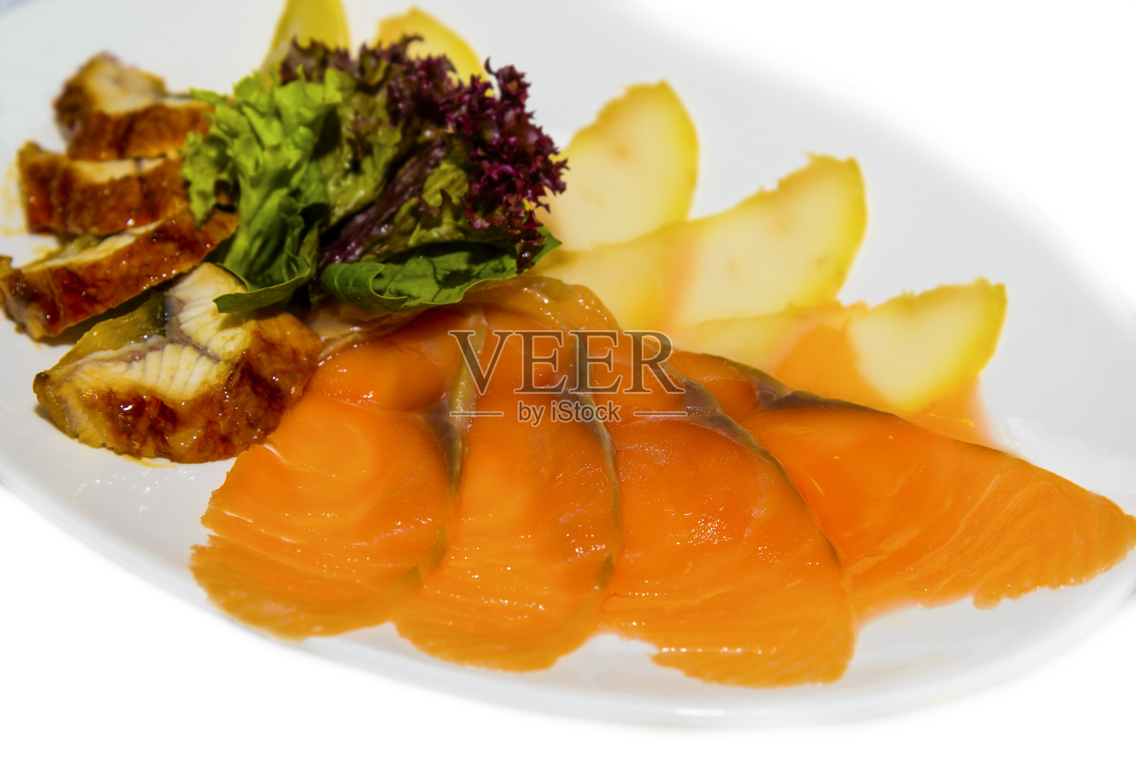 烟熏鲑鱼和烤鳟鱼配生菜。照片摄影图片