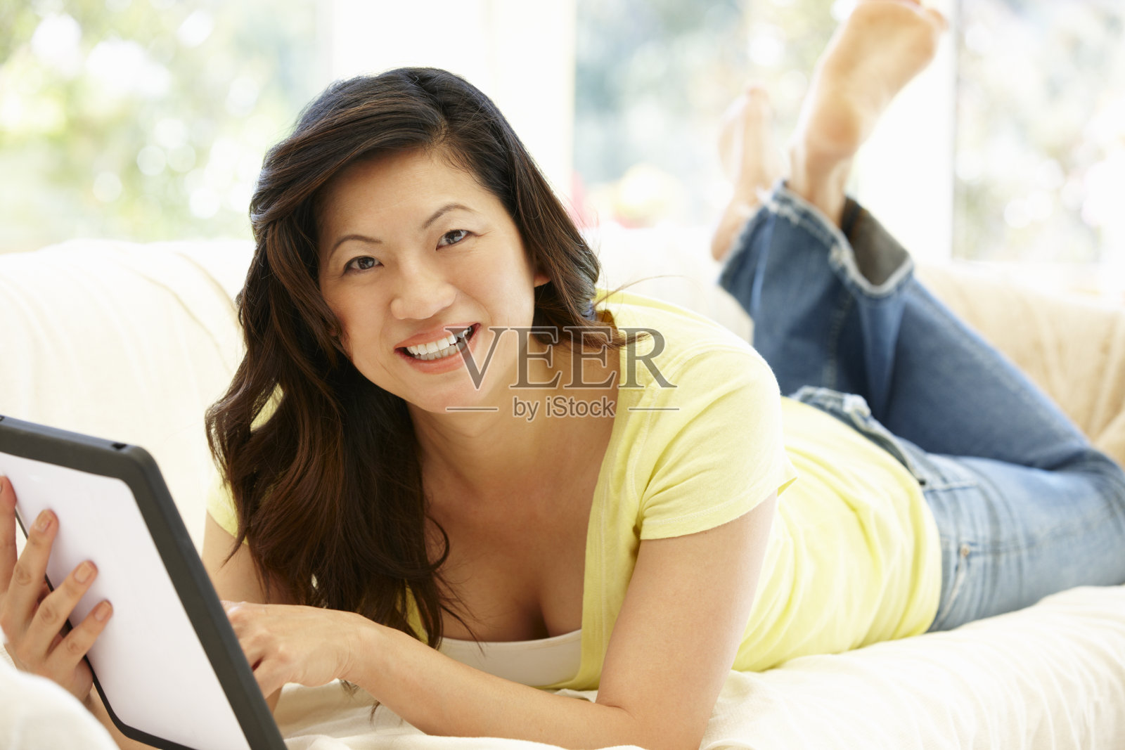 亚洲女性在家里使用平板电脑照片摄影图片