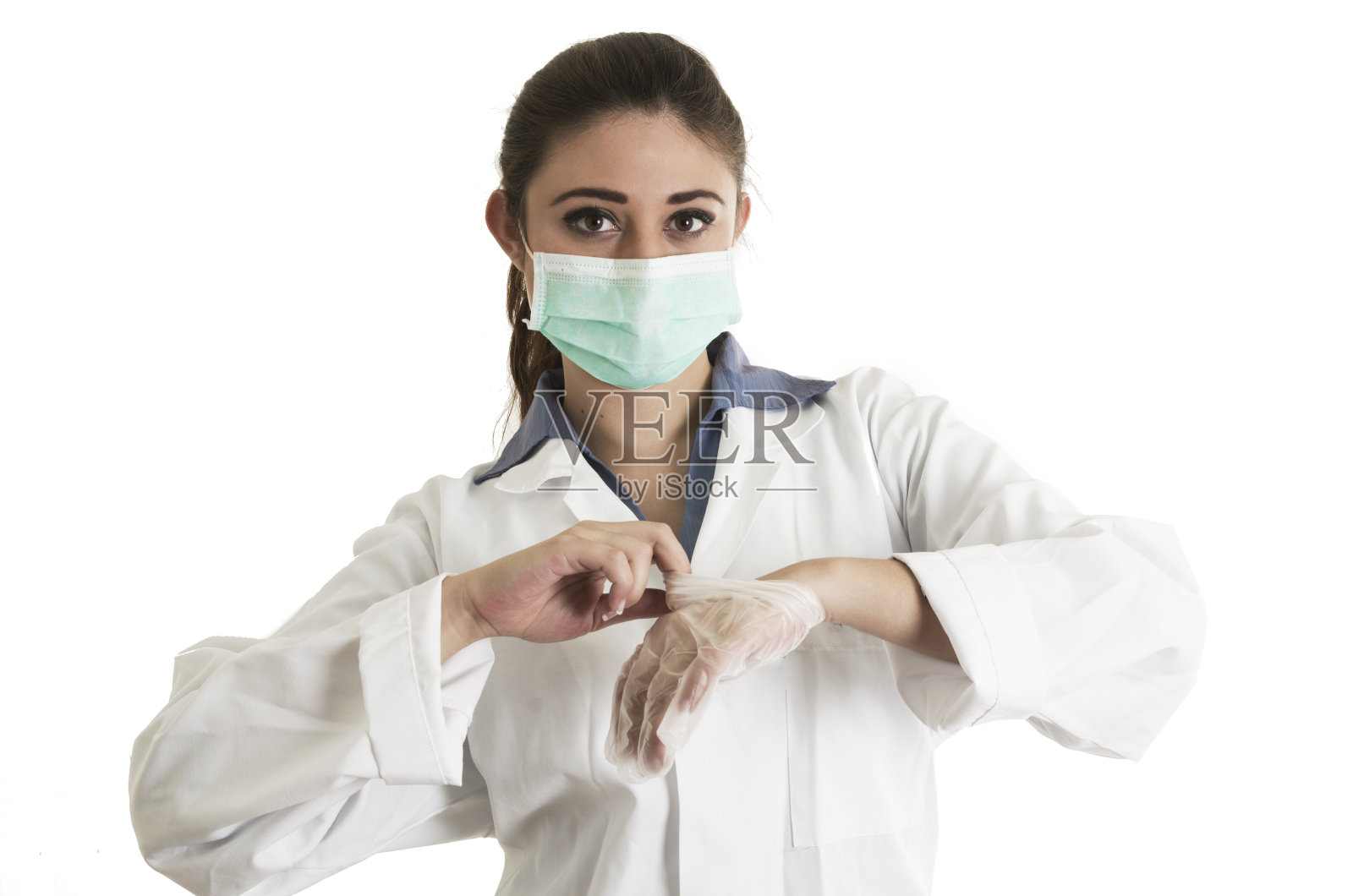 戴着手套和口罩的年轻女医生照片摄影图片