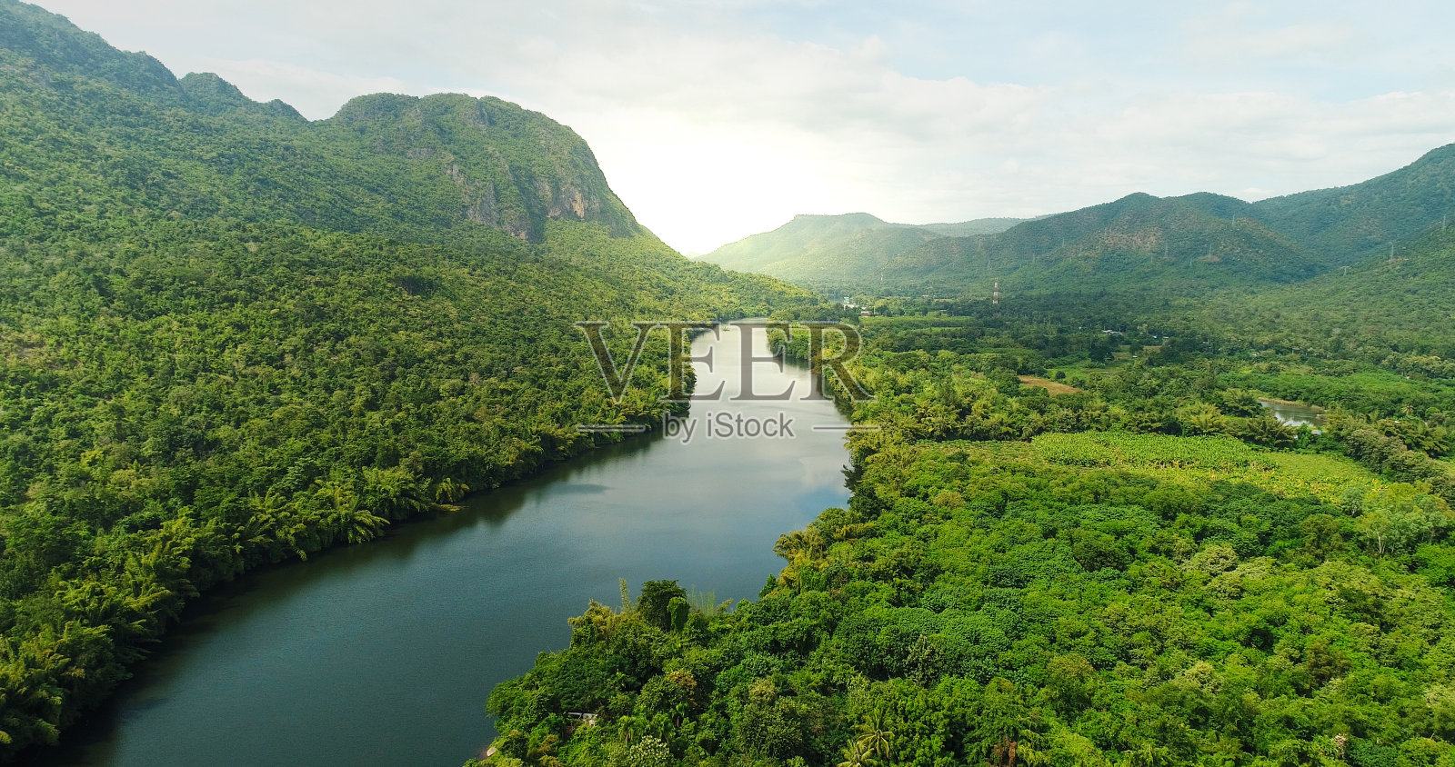 鸟瞰图的河流在热带绿色森林与山脉的背景照片摄影图片