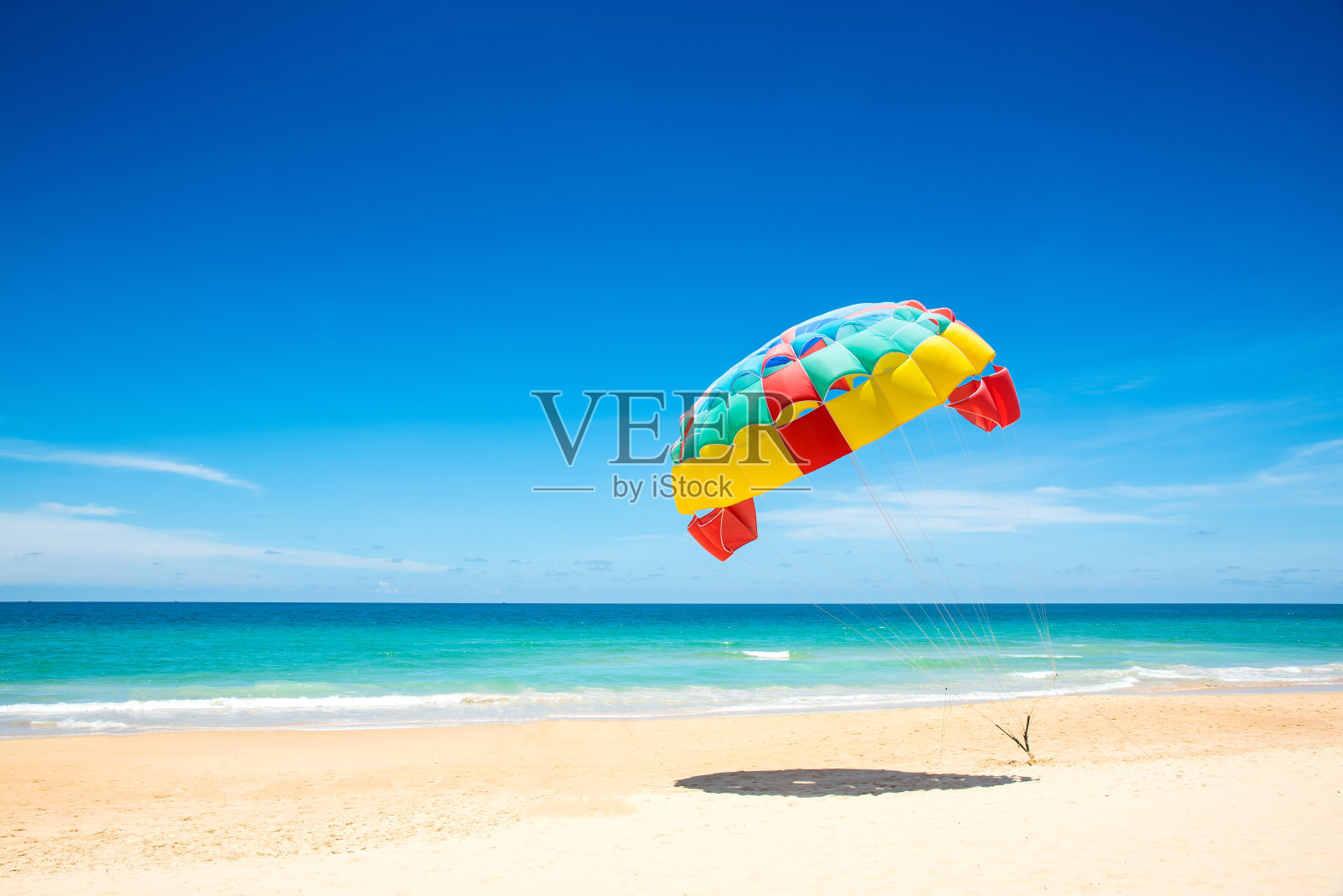 泰国普吉岛，海边拉着多彩的滑翔伞翼。照片摄影图片