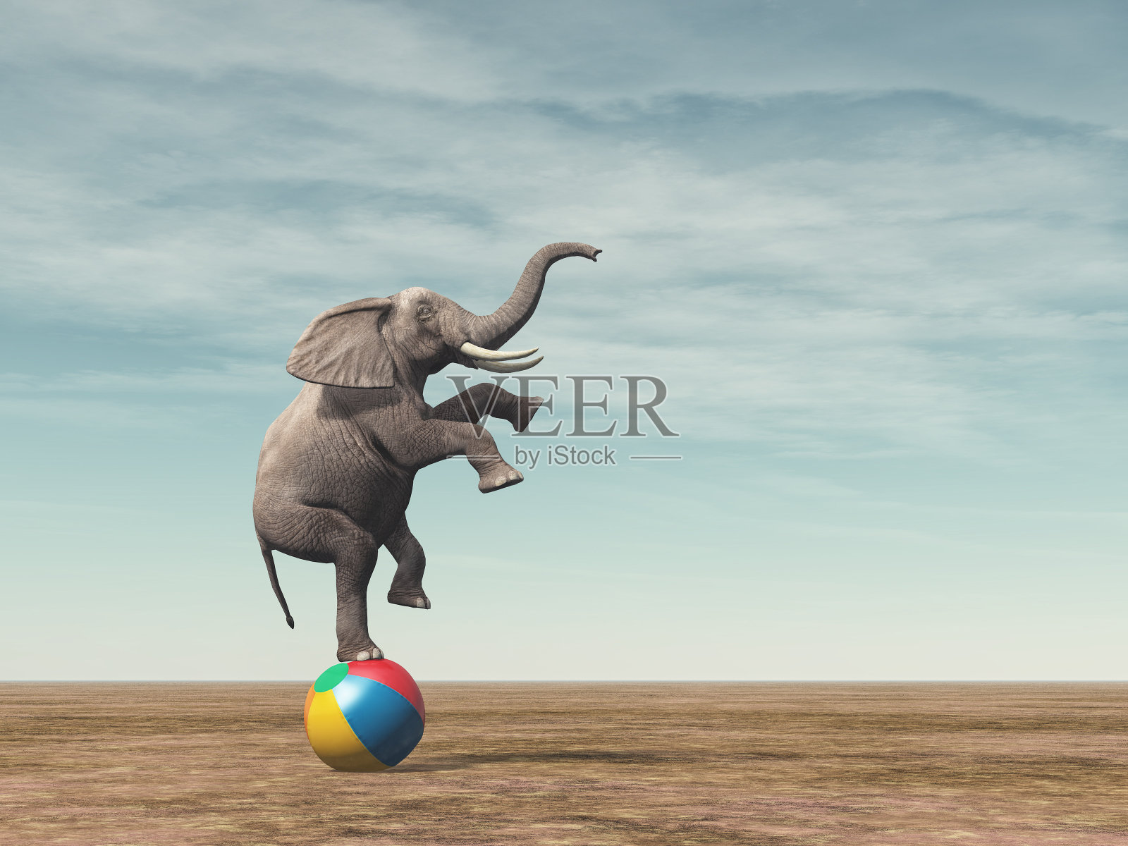 一只大象在沙滩球上保持平衡的超现实图像照片摄影图片