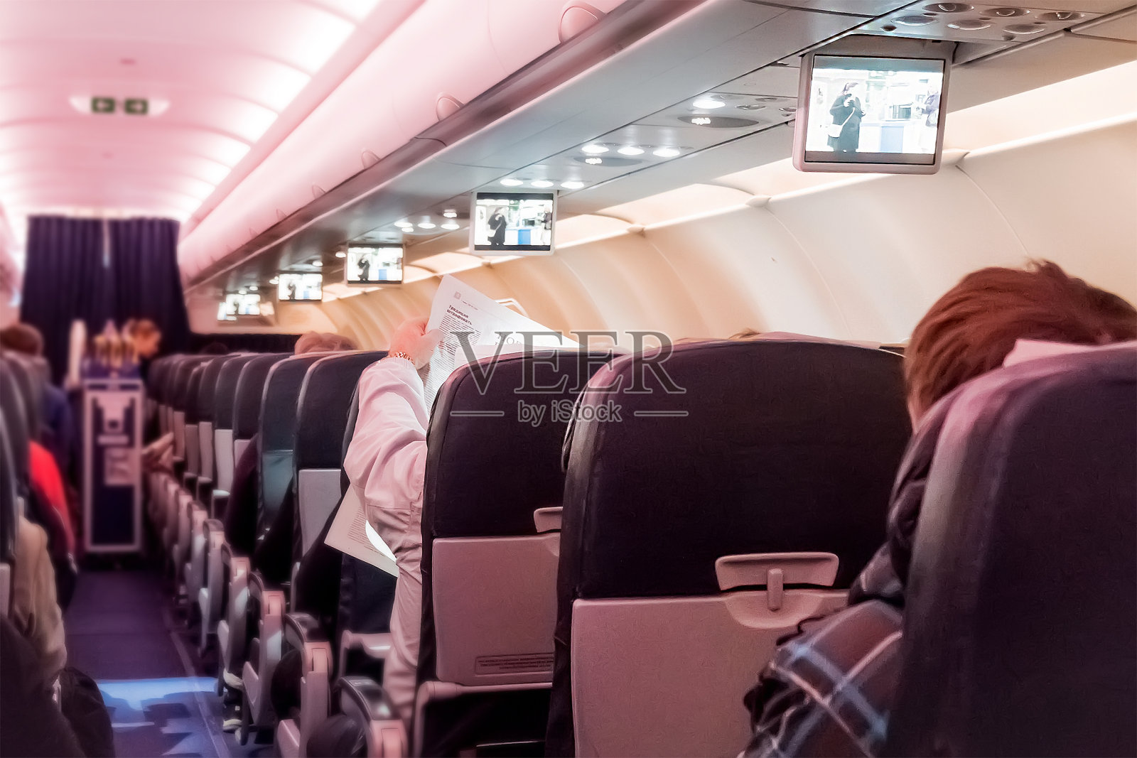 大型客机的内部，座位上有乘客。照片摄影图片