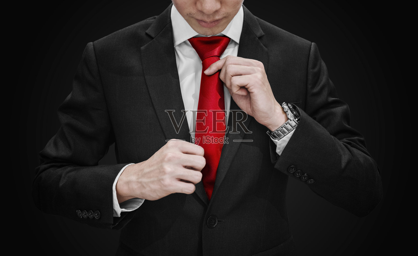 商人在黑色西装系红色领带在黑色背景照片摄影图片