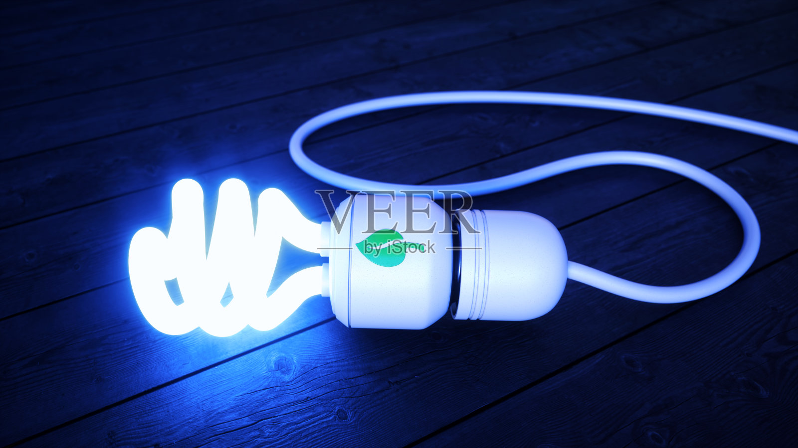 绿色能源灯泡在硬木地板上发出冷蓝色的光照片摄影图片