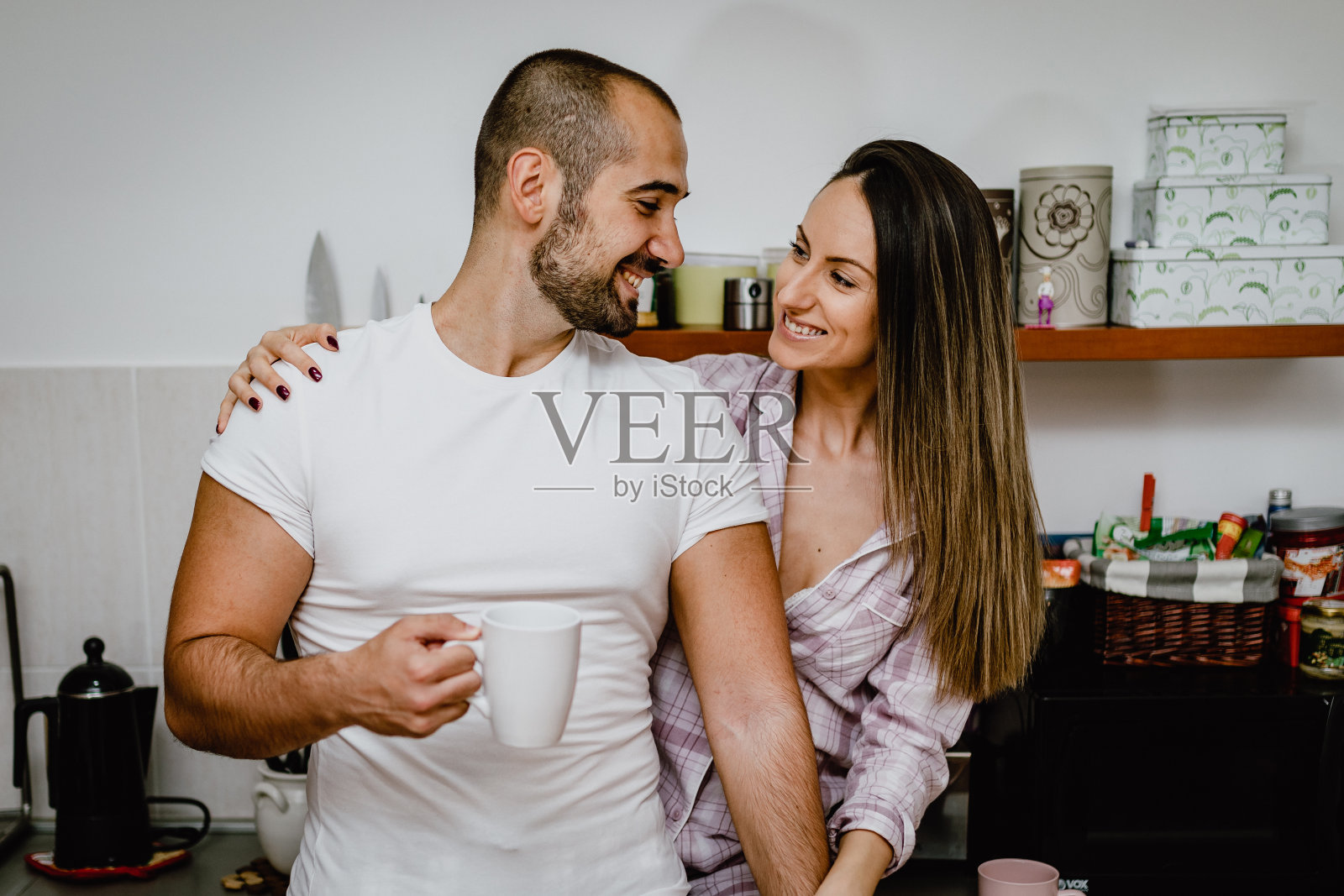 男朋友和女朋友在厨房喝咖啡，准备早餐照片摄影图片