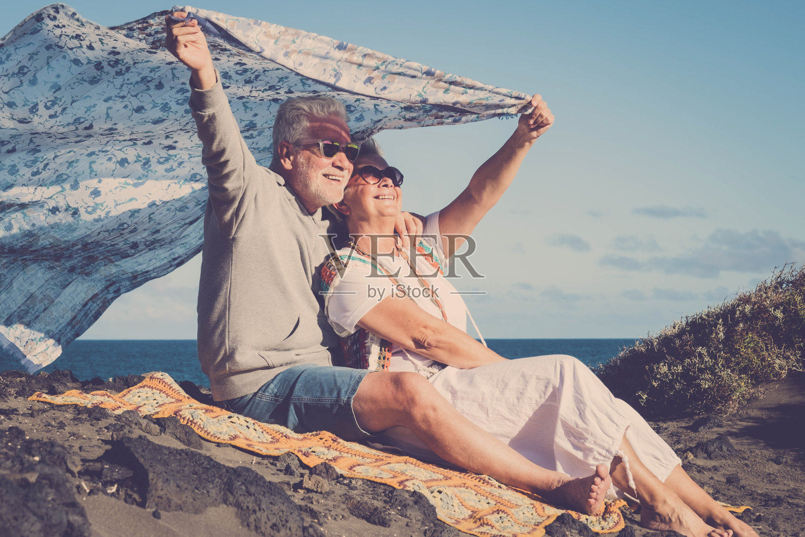 快乐的白种老夫妇一起享受户外休闲活动——活跃的相爱的老人们在阳光、海洋和大自然的背景下嬉戏照片摄影图片