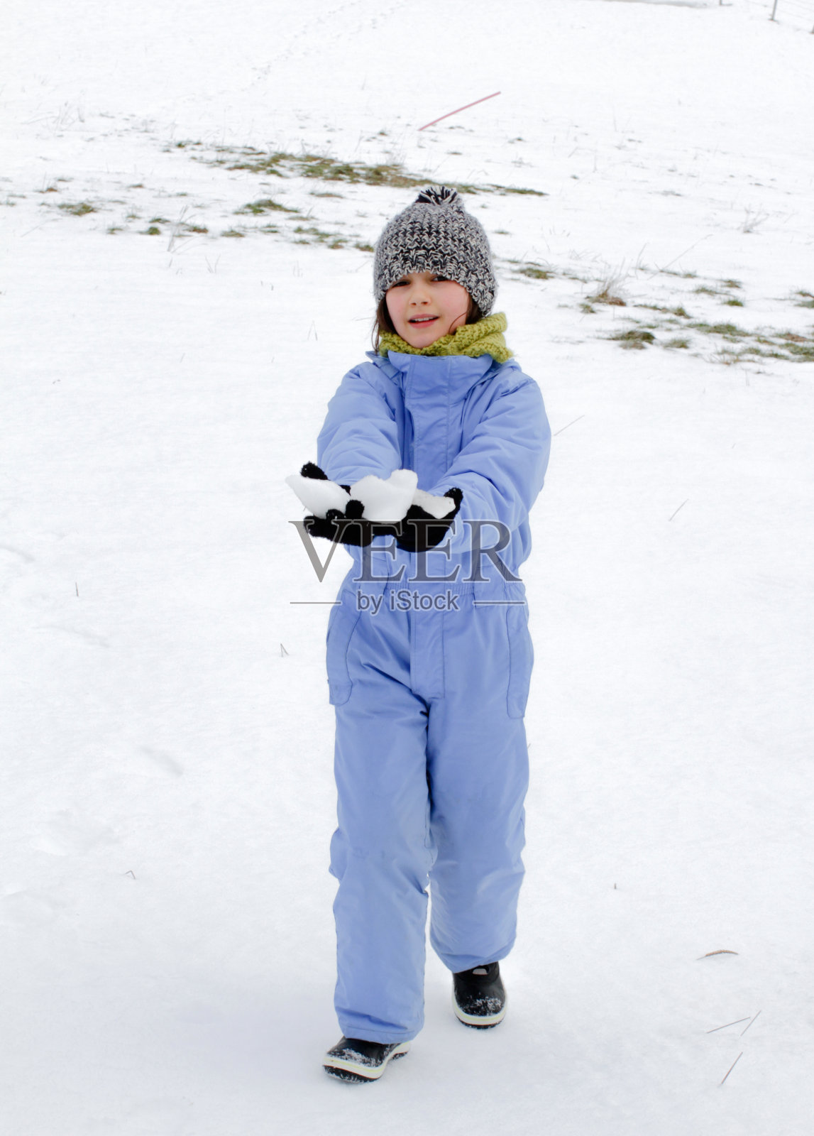 微笑的冬天的孩子与滑雪服行走在雪中照片摄影图片