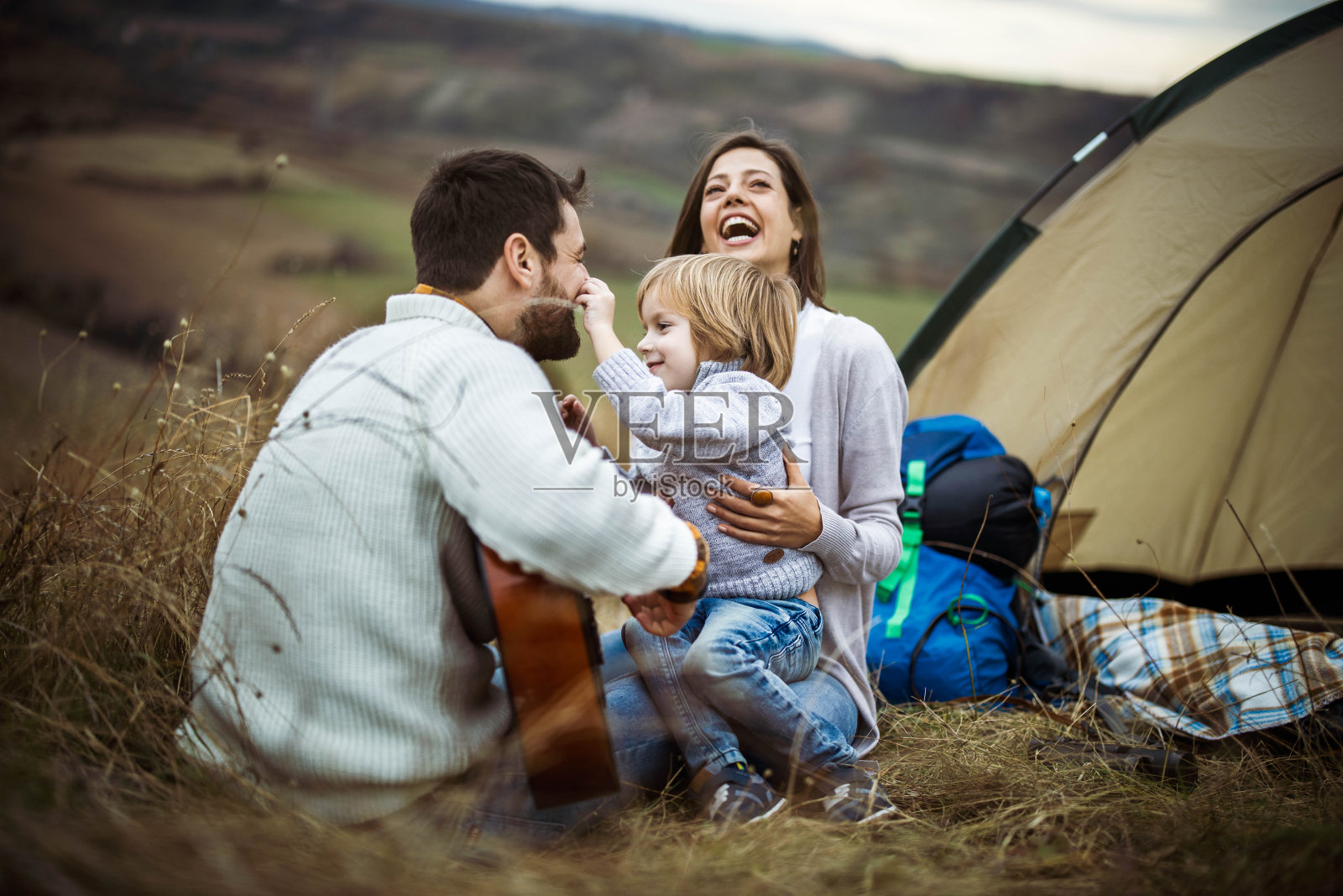 爱玩的家庭有乐趣的露营在秋天的一天在自然。照片摄影图片