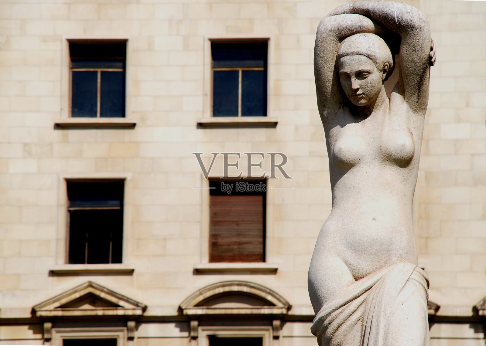 一个女人的雕塑和建筑与窗户的背景照片摄影图片