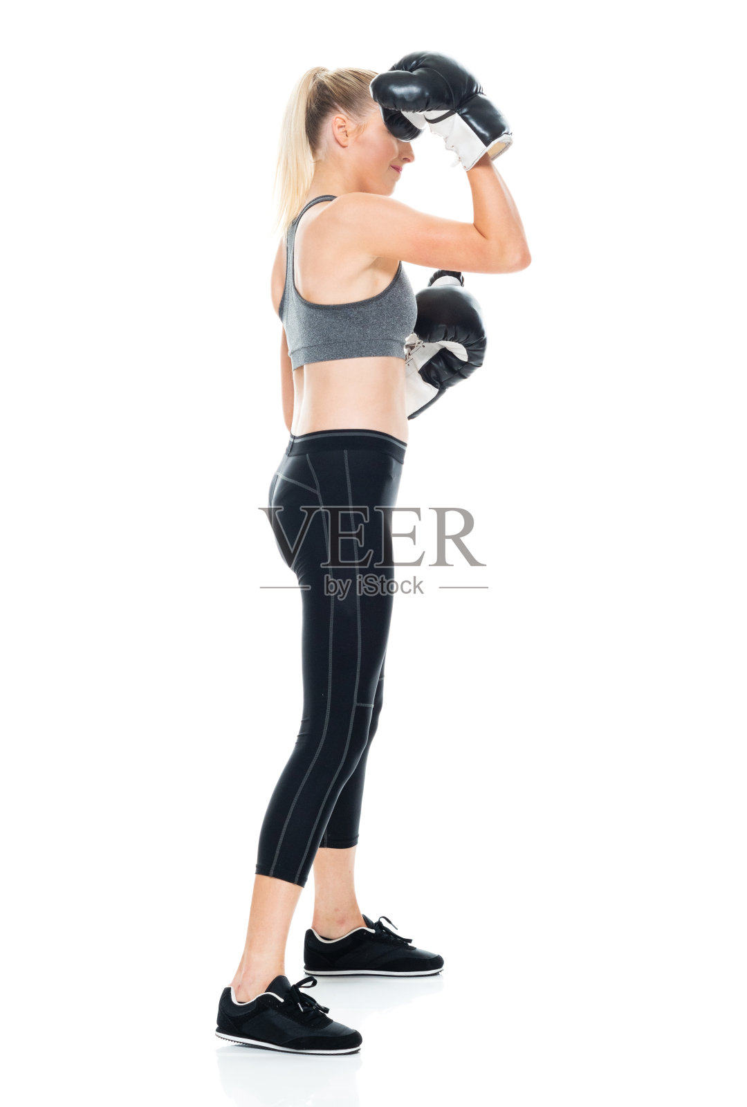 z一代的年轻女性戴着手套在白色背景前锻炼照片摄影图片