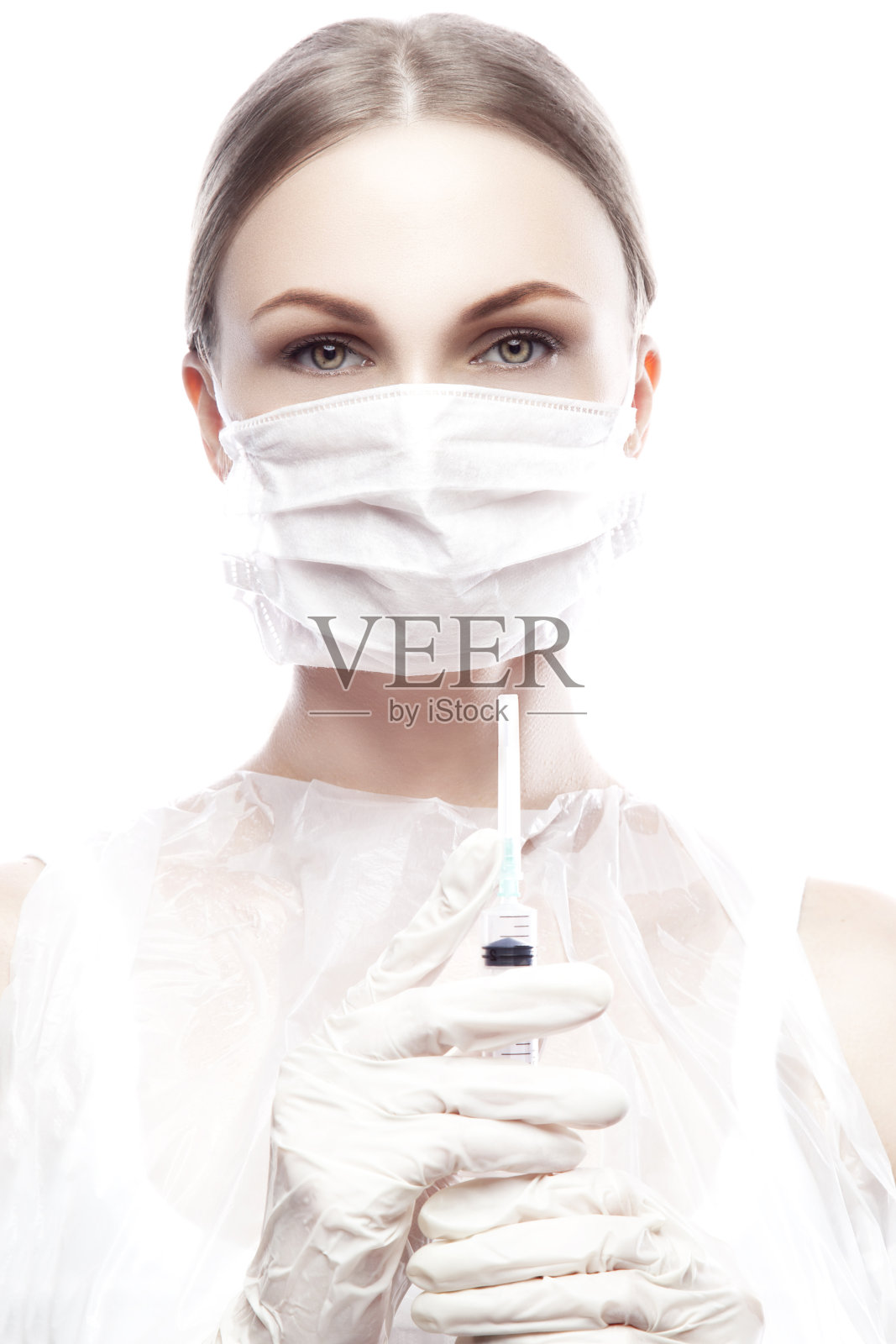 年轻女子在一个医疗面具持有注射器，美容和水疗照片摄影图片