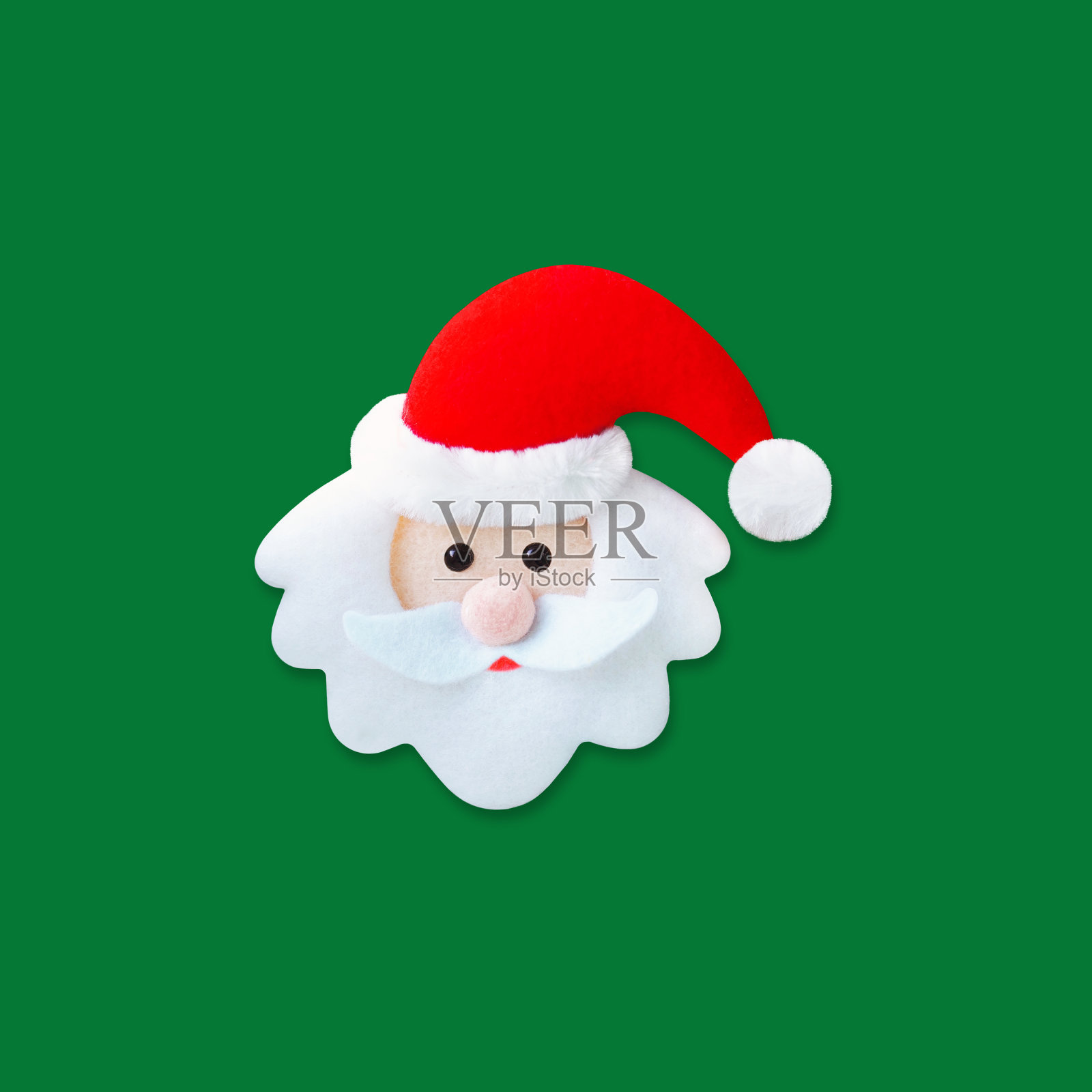 圣诞老人。圣诞老人的脸在红色的帽子孤立在绿色的背景照片摄影图片