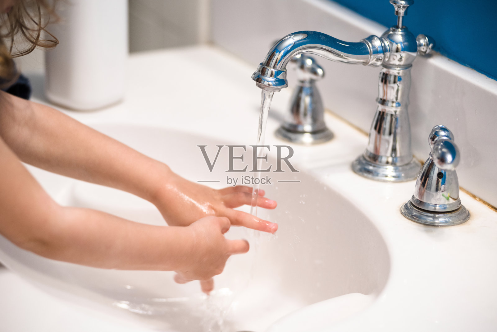 2019冠状病毒病大流行期间，一名无法辨认的女孩小心洗手照片摄影图片