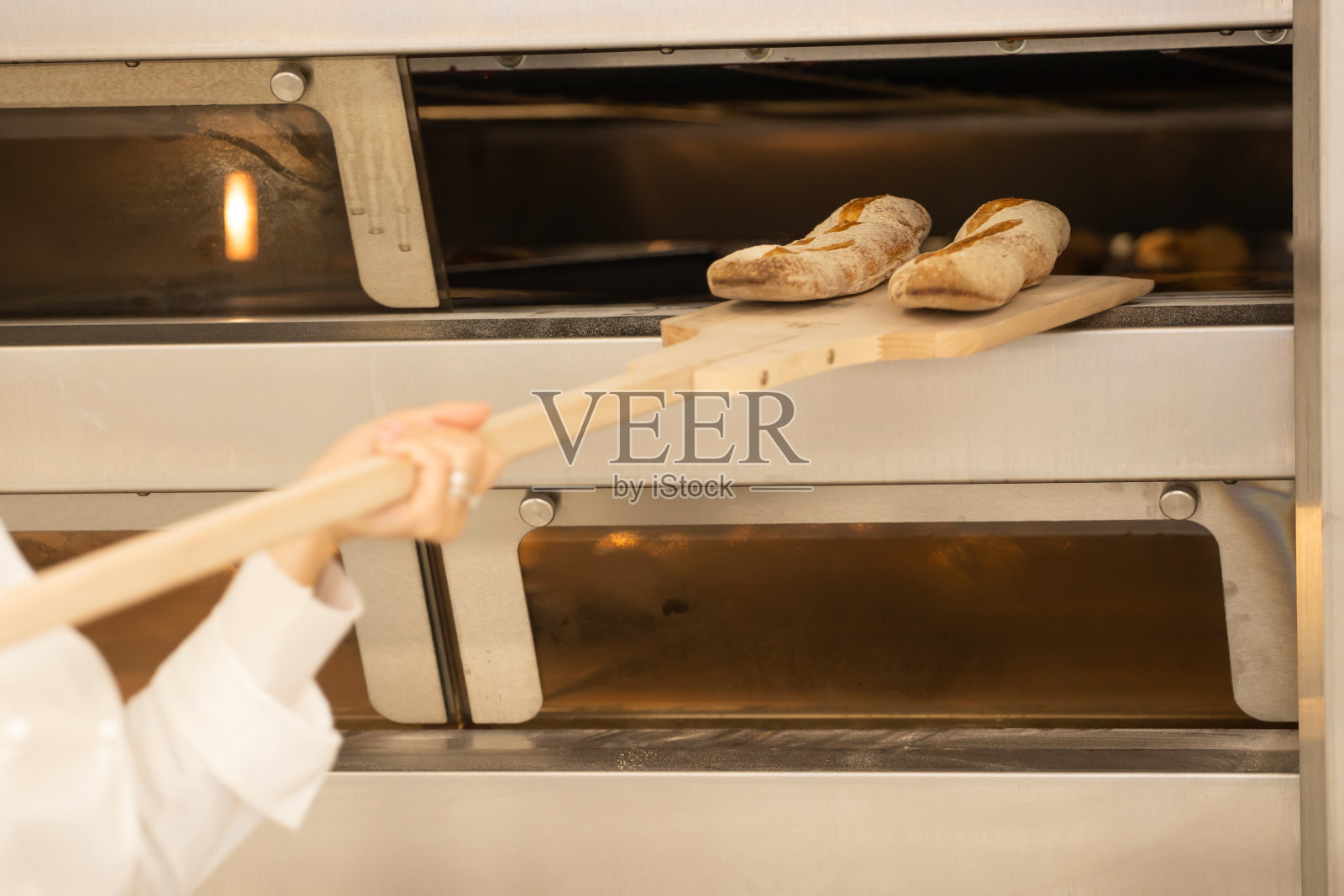在面包店用烤箱烤面包。照片摄影图片