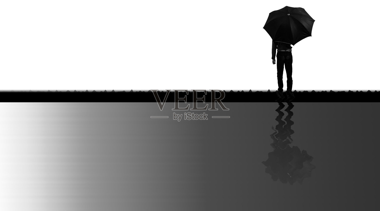 一个拿着伞的男人站在一个奇怪的阴影下。照片摄影图片