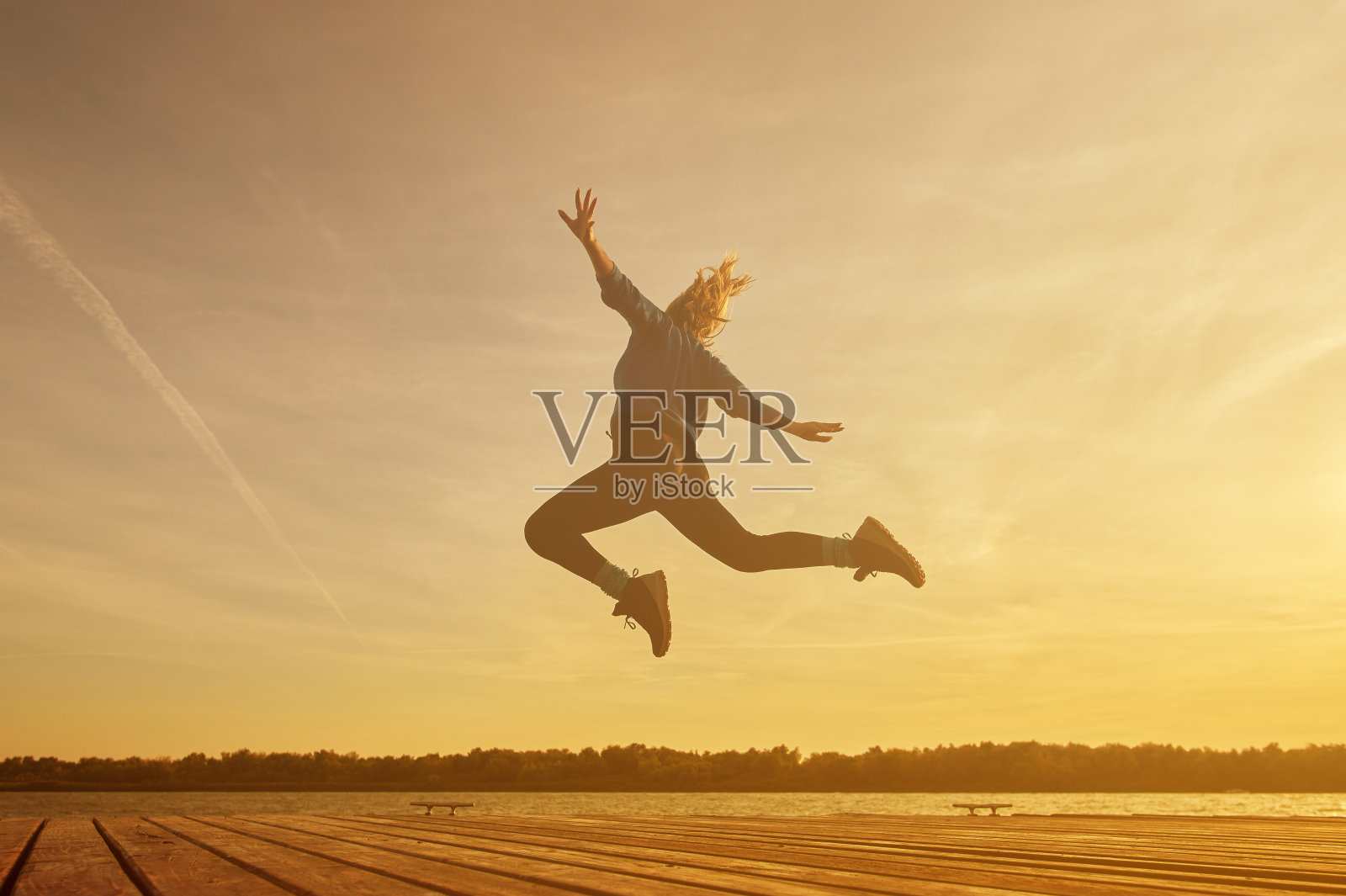 快乐的女人在大自然中跳跃照片摄影图片