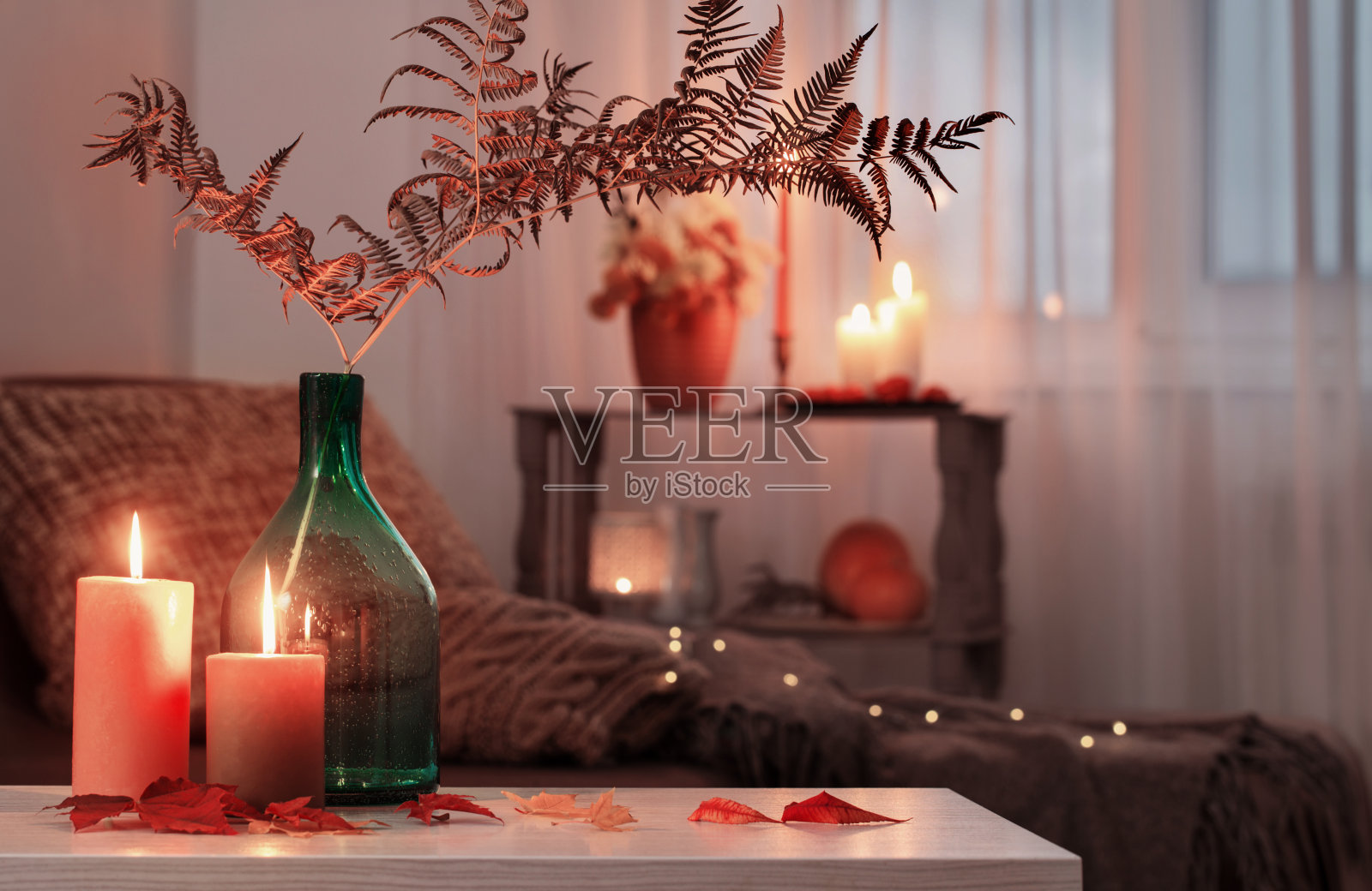 在家里白色的桌子上点燃秋天装饰的蜡烛照片摄影图片