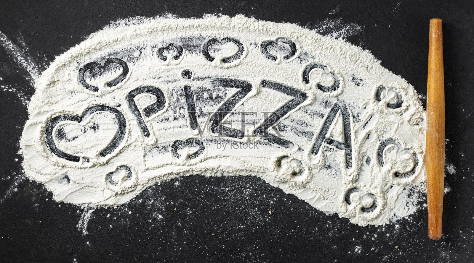 用擀面杖在面粉上写着“披萨”和心，俯视图。文摘烘焙背景照片摄影图片