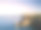 日落时意大利海岸的鸟瞰图，地中海上有一座灯塔。波尔图切尔沃-翡翠海岸，撒丁岛-意大利素材图片